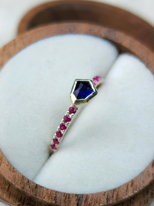 Dark blue horizontal natural winza sapphire,  sterling silver ring, set in 10 karat yellow gold bezel with 12 synthetic 1.5mm rubies