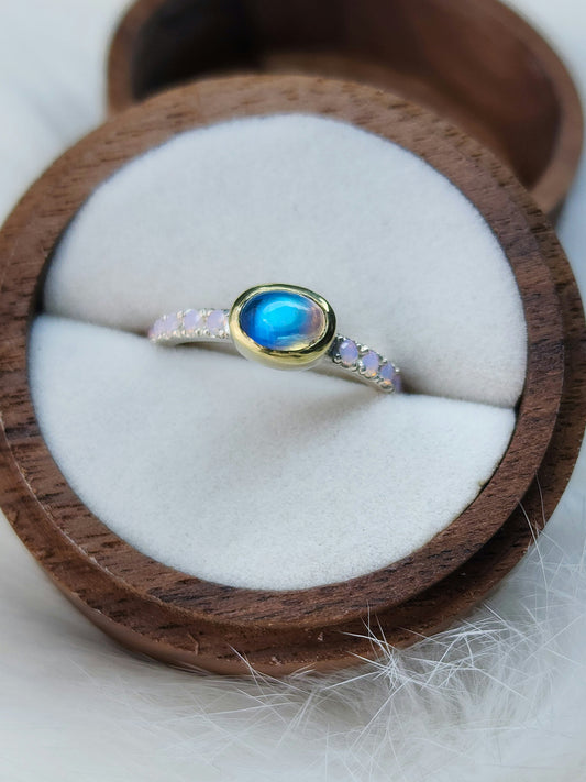 Horizontal set natural rainbow moonstone in 14 karat yellow gold bezel, with ten 2mm pave set synthetic pink opals