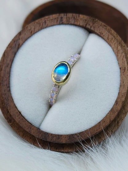 Horizontal set natural rainbow moonstone in 14 karat yellow gold bezel, with ten 2mm pave set synthetic pink opals