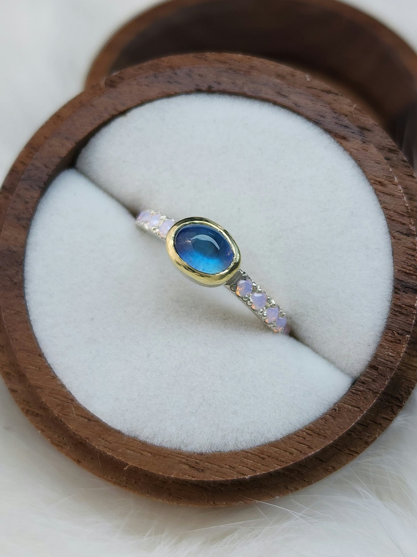 Horizontal set natural rainbow moonstone in 14 karat yellow gold bezel, with ten 2mm pave set synthetic pink opals