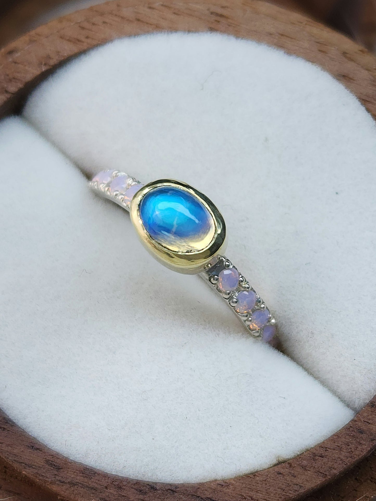 Horizontal set natural rainbow moonstone in 14 karat yellow gold bezel, with ten 2mm pave set synthetic pink opals