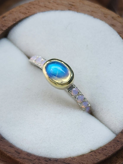 Horizontal set natural rainbow moonstone in 14 karat yellow gold bezel, with ten 2mm pave set synthetic pink opals