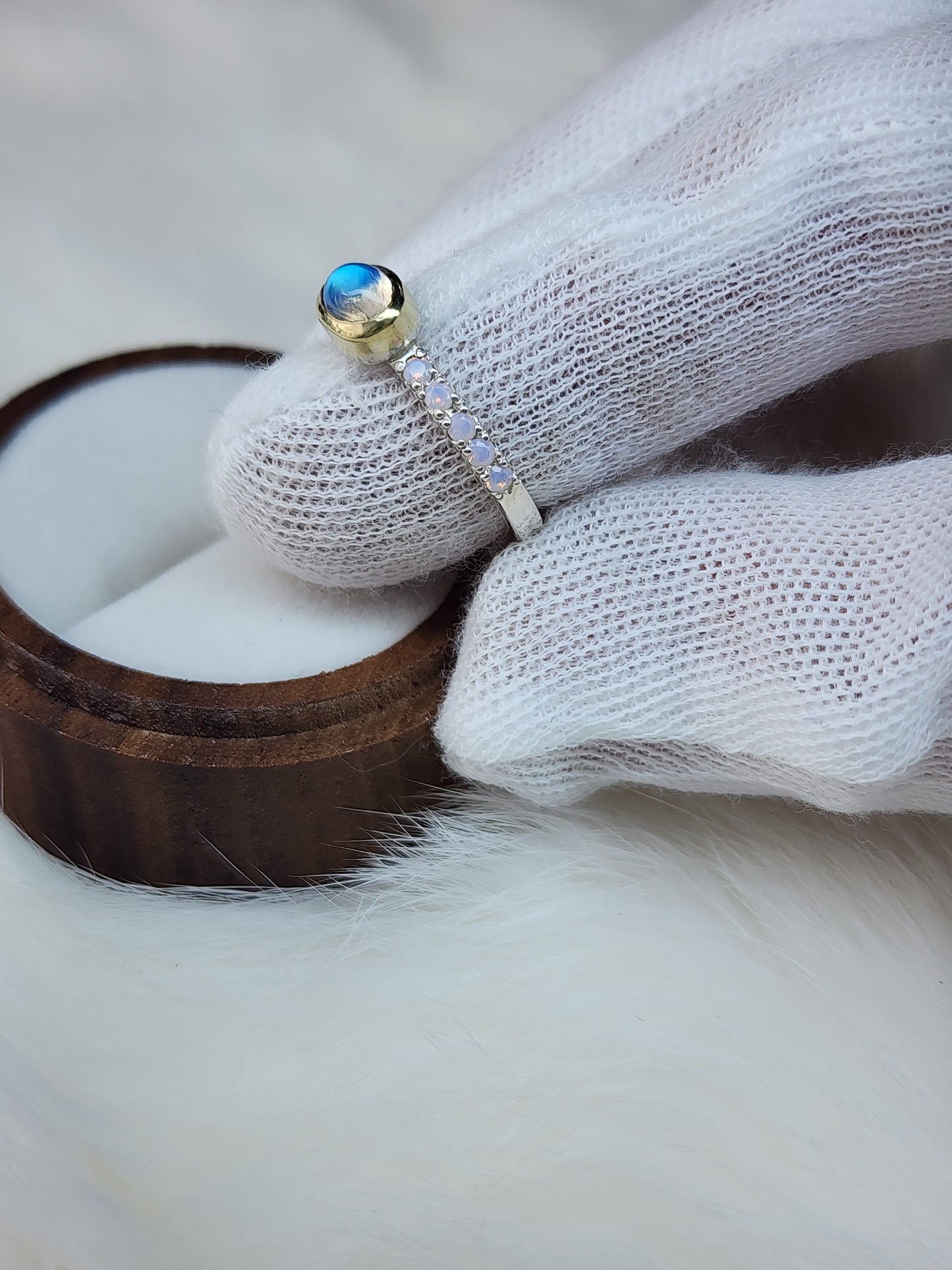 Horizontal set natural rainbow moonstone in 14 karat yellow gold bezel, with ten 2mm pave set synthetic pink opals