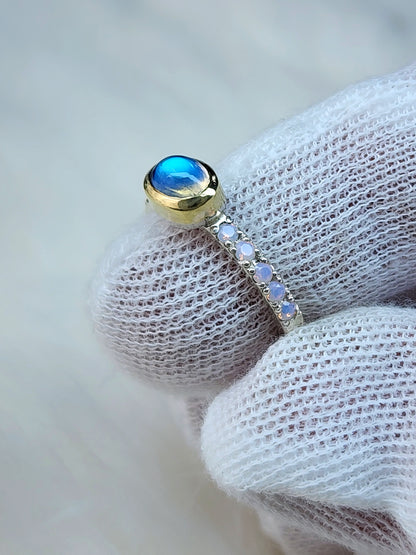 Horizontal set natural rainbow moonstone in 14 karat yellow gold bezel, with ten 2mm pave set synthetic pink opals