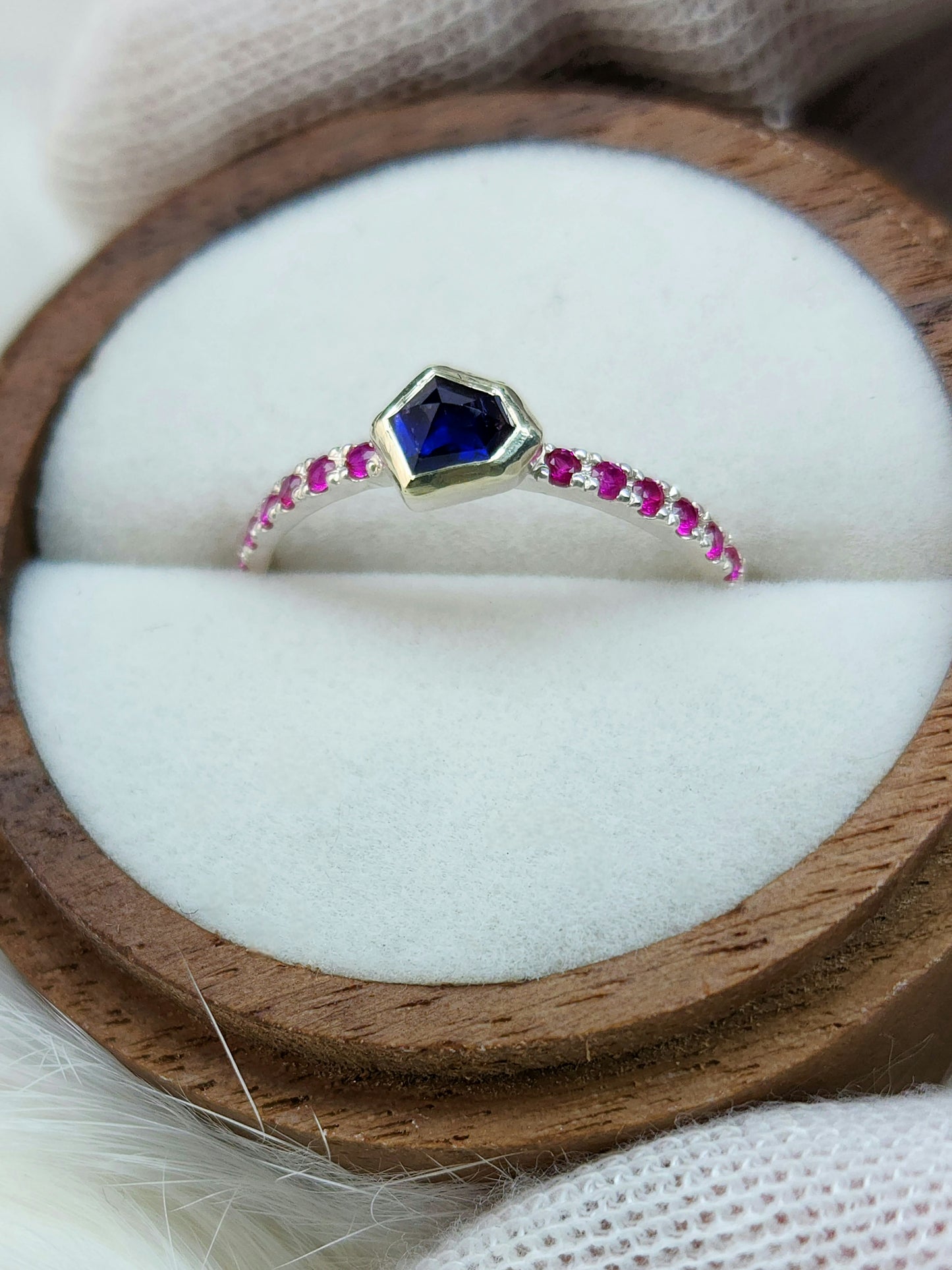 Dark blue horizontal natural winza sapphire,  sterling silver ring, set in 10 karat yellow gold bezel with 12 synthetic 1.5mm rubies