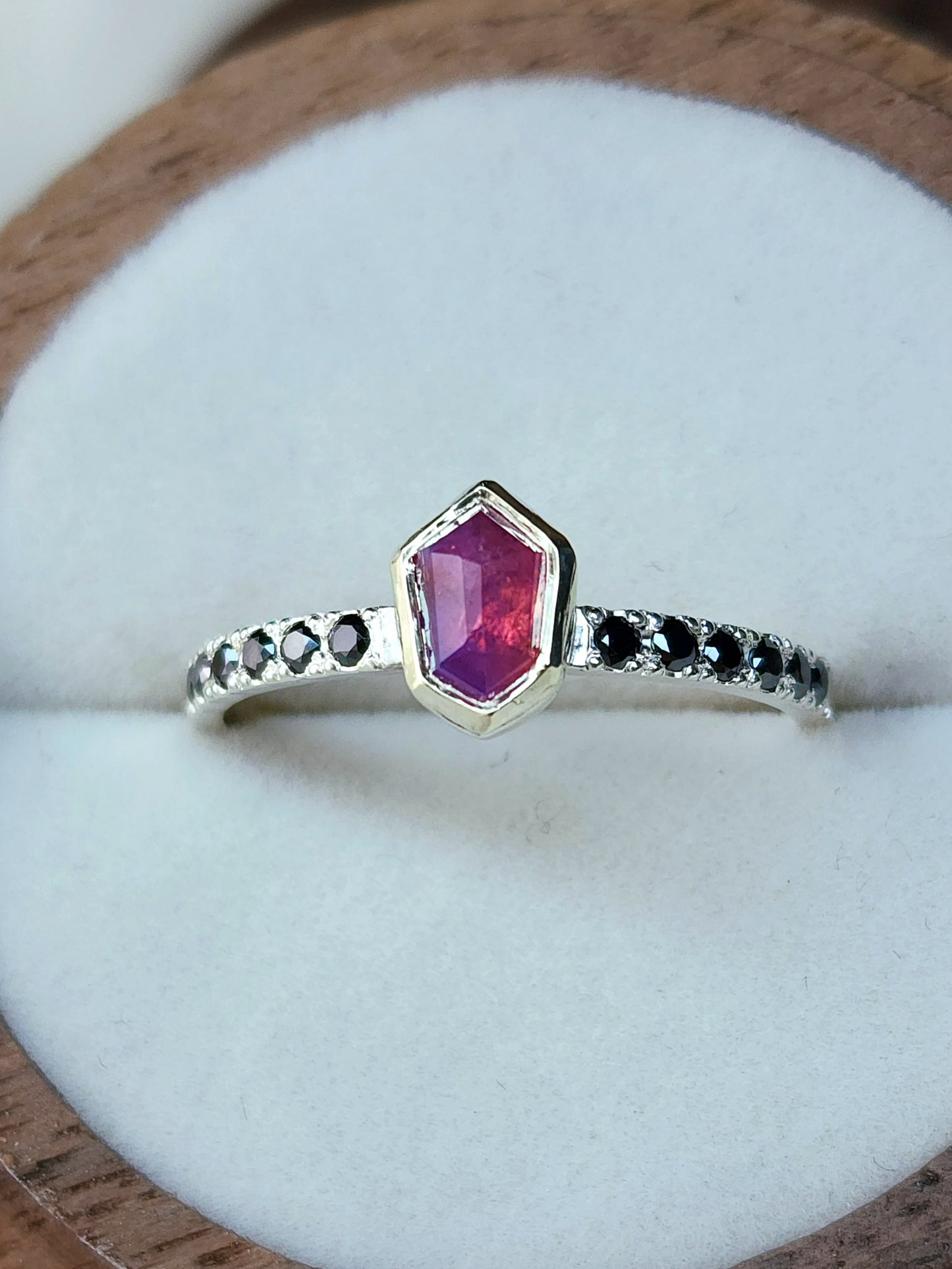 Opalescent pink sapphire shield winza sapphire sterling silver ring with 12-1.5 mm pave set black moissanites in a 10 karat yellow gold bezel
