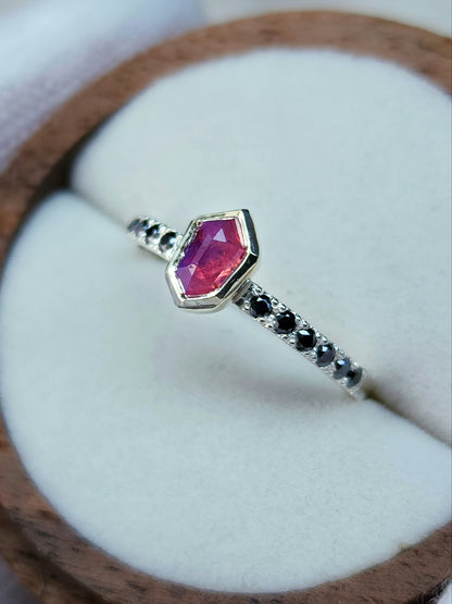 Opalescent pink sapphire shield winza sapphire sterling silver ring with 12-1.5 mm pave set black moissanites in a 10 karat yellow gold bezel