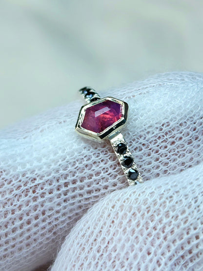 Opalescent pink sapphire shield winza sapphire sterling silver ring with 12-1.5 mm pave set black moissanites in a 10 karat yellow gold bezel