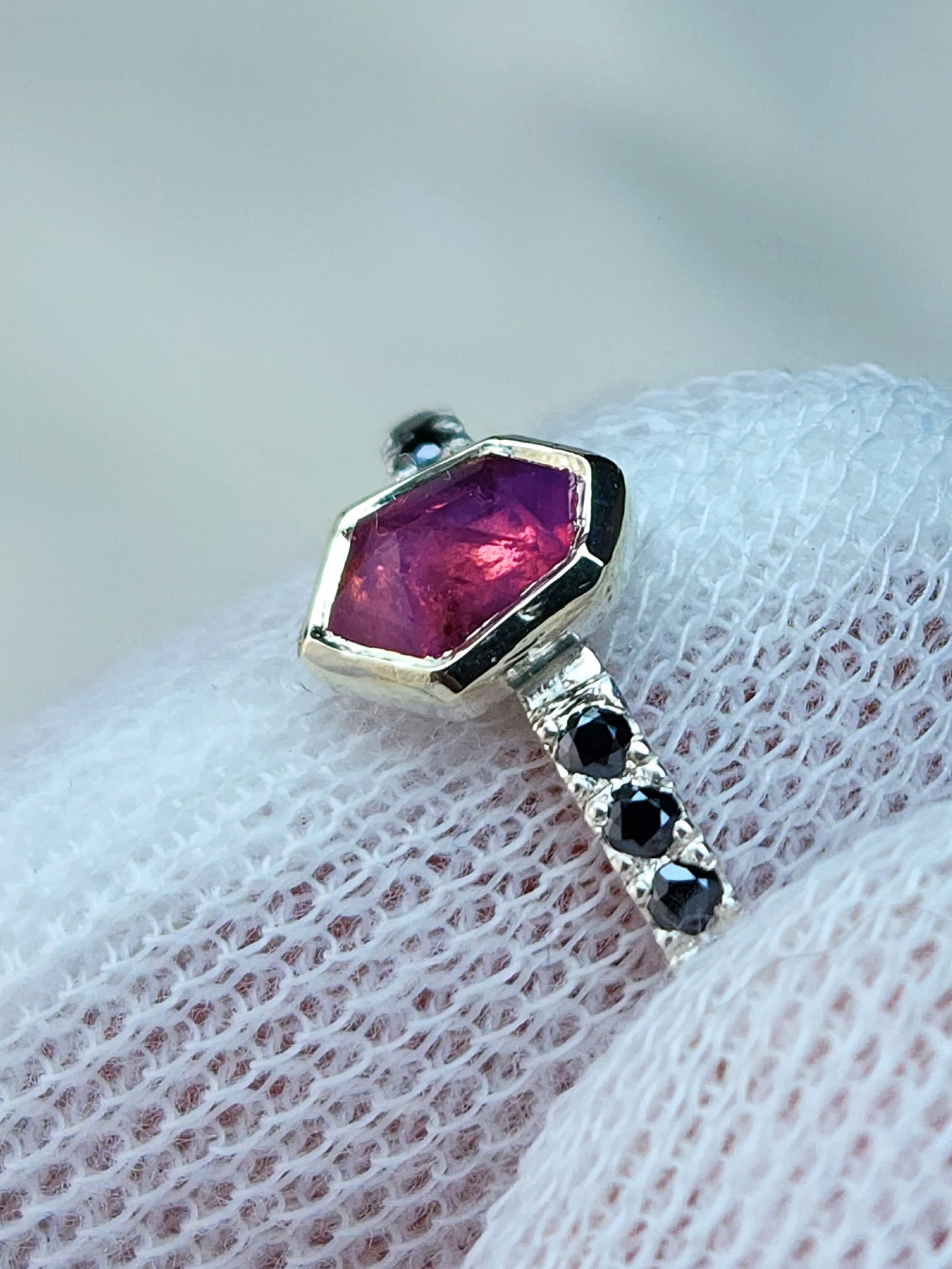 Opalescent pink sapphire shield winza sapphire sterling silver ring with 12-1.5 mm pave set black moissanites in a 10 karat yellow gold bezel