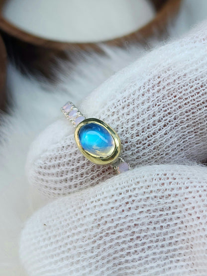 Horizontal set natural rainbow moonstone in 14 karat yellow gold bezel, with ten 2mm pave set synthetic pink opals