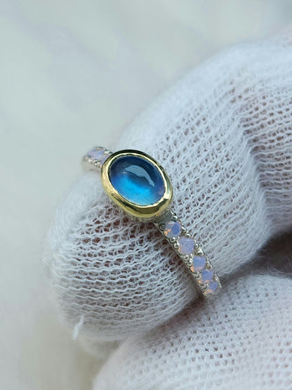 Horizontal set natural rainbow moonstone in 14 karat yellow gold bezel, with ten 2mm pave set synthetic pink opals