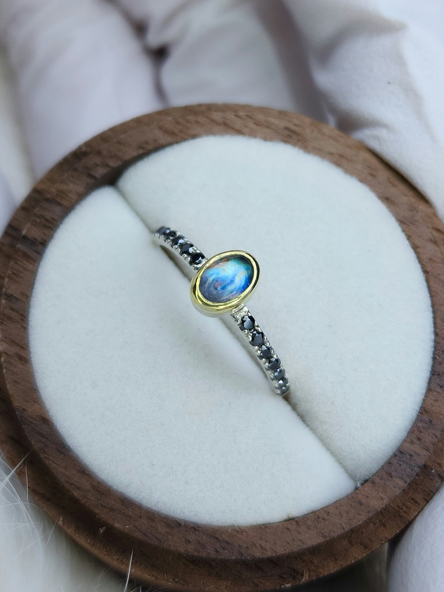 Rainbow moonstone ring, 14 karat yellow gold, bezel, 1.5mm diamond cut black moissanite pave